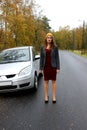 The autumn day the car broke down and the girl in a dress with a hat catches another car to help