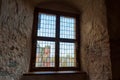 Autumn day light going through vintage stained-glass window in wall niche in the dark medieval castle