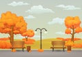 Autumn day park scene. Benches, trash cans and street lamp the park trail. Withered meadow on the background. Royalty Free Stock Photo