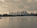 Autumn day view across inner bays of Lake Ontario in Tommy Thompson Park with foggy Downtown Toronto skyline under grey Royalty Free Stock Photo