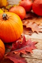 Autumn decor from pumpkins, berries and leaves on a white  wooden background. Concept of Thanksgiving day or Halloween. Flat lay Royalty Free Stock Photo