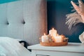 Autumn decor in stylish modern bedroom. Cozy interior with dark emerald wall, bed with grey fabric headboard Royalty Free Stock Photo