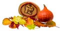 Autumn decoration with colorful foliage and Hokkaido pumpkin and a wooden plate with German inscription `Autumn`