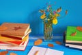 Autumn. Different colorful books, autumn leaves and bouquet of wildflowers. Copy space