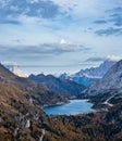 Autumn Dolomites mountain scene from hiking path betwen Pordoi Pass and Fedaia Lake, Italy. Snowy Marmolada Glacier and Fedaia