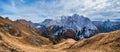 Autumn Dolomites mountain scene from hiking path betwen Pordoi Pass and Fedaia Lake, Italy. Snowy Marmolada Glacier and Fedaia