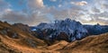 Autumn Dolomites mountain scene from hiking path betwen Pordoi Pass and Fedaia Lake, Italy. Snowy Marmolada Glacier and Fedaia Royalty Free Stock Photo