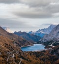 Autumn Dolomites mountain scene from hiking path betwen Pordoi Pass and Fedaia Lake, Italy. Snowy Marmolada Glacier and Fedaia Royalty Free Stock Photo