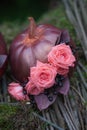 Autumn DÃÂ©cor with bouquet of roses and grapes in the golden pumpkin. Stylish Halloween decorations. Shiny Decorative Pumpkins. Royalty Free Stock Photo