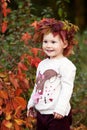 Autumn emotional portrait of little  girl. Pretty little girl with red grape leaves in autumn park. Autumn activities for children Royalty Free Stock Photo