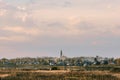 autumn evening landscape with a field and a river and a Christian Church on the horizon Royalty Free Stock Photo