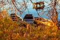 Autumn evening on a deserted river bank with an old fishing bridge and three fishing boats. nobody Royalty Free Stock Photo