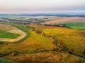 Autumn evening rural aerial view with river, creek, brook, vill