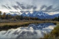 autumn evening shot of the snow covered teton mountains reflected in calm water at schwabachers landing of grand tetons Royalty Free Stock Photo