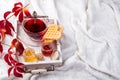 Autumn fall concept with knitted blanket and hot tea with waffer, jam, honey on wooden tray on te bed, autumn leaf and Royalty Free Stock Photo