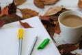 Autumn, fall concept There are colored leaves ,coffee cup and notebook.