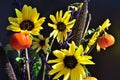 Pumpkin on a stick sunflower millet grass purple filler autumn bouquet closeup horizontal