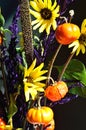 Pumpkin on a stick sunflower millet grass purple filler autumn bouquet closeup vertical