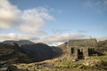 Autumn Fall landscape image of old bothy in Lake Districtr mountains near Buttermere with Haystacks and High Stiel in the distance Royalty Free Stock Photo