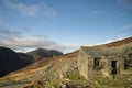 Autumn Fall landscape image of old bothy in Lake Districtr mountains near Buttermere with Haystacks and High Stiel in the distance