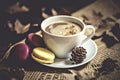 Autumn, fall leaves, hot steaming cup of cappuccino coffees, macaroons, cones on wooden table background. Royalty Free Stock Photo