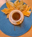 Autumn, fall leaves, hot steaming cup of coffee tea on wooden table background. Royalty Free Stock Photo