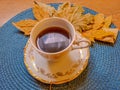 Autumn, fall leaves, hot steaming cup of coffee tea on wooden table background. Royalty Free Stock Photo