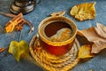 Autumn, fall leaves, a hot steaming cup of coffee and a warm scarf against the background of a blue table. Seasonal, morning Royalty Free Stock Photo