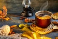 Autumn, fall leaves, a hot steaming cup of coffee and a warm scarf against the background of a blue table. Seasonal, morning Royalty Free Stock Photo