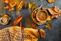 Autumn, fall leaves, a hot steaming cup of coffee and a warm scarf against the background of a blue table. Seasonal, morning Royalty Free Stock Photo