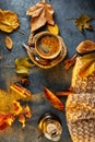 Autumn, fall leaves, a hot steaming cup of coffee and a warm scarf against the background of a blue table. Seasonal, morning Royalty Free Stock Photo