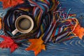 Autumn, fall leaves, hot steaming cup of coffee and a warm scarf Royalty Free Stock Photo