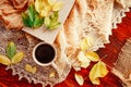 Autumn, fall leaves, hot steaming cup of coffee and a warm scarf on wooden table background. Seasonal, morning coffee Royalty Free Stock Photo