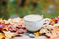 Autumn, fall leaves, hot steaming cup of coffee on wooden table background. Seasonal, morning coffee, Sunday relaxing and still li Royalty Free Stock Photo