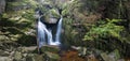 Autumn fall mountain waterfall stream in the rocks with colorful fallen dry leaves, landscape, natural seasonal background Royalty Free Stock Photo