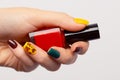 Autumn fall nail art trend. Hand with professional manicure holding nail polish bottle