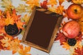 Autumn and Fall season. Empty photo frame and fake maple leaf on wood table. Harvest cornucopia and Thanksgiving day