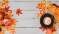 Autumn and Fall season. Hot coffee with fake maple leaf on wood table. Harvest cornucopia and Thanksgiving day