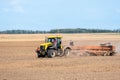 In the autumn, the farmer processes the fields with the tractor and sows the seeds for the next harvest.