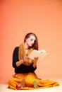 Autumn fashion girl with book orange eye-lashes Royalty Free Stock Photo