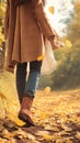 Autumn fashion woman in jeans and boots walking in park Royalty Free Stock Photo