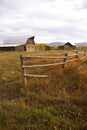 Autumn, fence and old western farm buildings Royalty Free Stock Photo