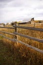 Autumn, fence and old western farm buildings Royalty Free Stock Photo