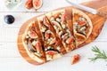 Autumn flat bread pizza with figs, caramelized onions, blue cheese and rosemary, top view table scene on white wood Royalty Free Stock Photo