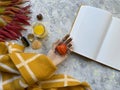 Autumn flat lay composition dry leaves, wooden holding hand and notebook