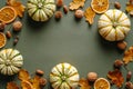 Autumn flat lay composition with pumpkins, dry oranges, acorns, oak leaves on green background. Vintage Thanksgiving day card