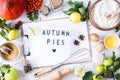 Autumn flat lay with lightbox with the phrase Autumn pies. Top view. Food ingredients for making autumn pumpkin pie on a white Royalty Free Stock Photo