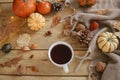 Autumn flat lay. Warm cup of tea, pumpkins, fall leaves, cozy scarf on rustic wooden table. Hygge autumn banner. Happy Royalty Free Stock Photo