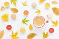 Autumn flatlay. Coffee, candles, leaves, macaroons