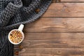 Autumn flatlay composition with cup of herbal tea and wool plaid. Cozy home, hygge concept. Flat lay, top view, copy space